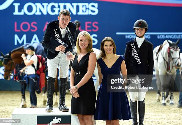 First place finisher Jos Verlooy of Belgium and third place finisher Georgina Bloomberg pose on the podium with Fernanda Ameeuw after competing in...