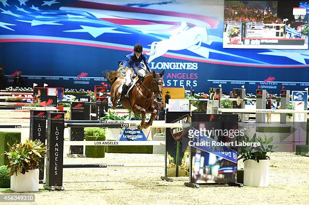 Rider Janika Sprunger of Switzerland rides Aris Cms during the Longines Grand Prix class as part of the Longines Los Angeles Masters at Los Angeles...