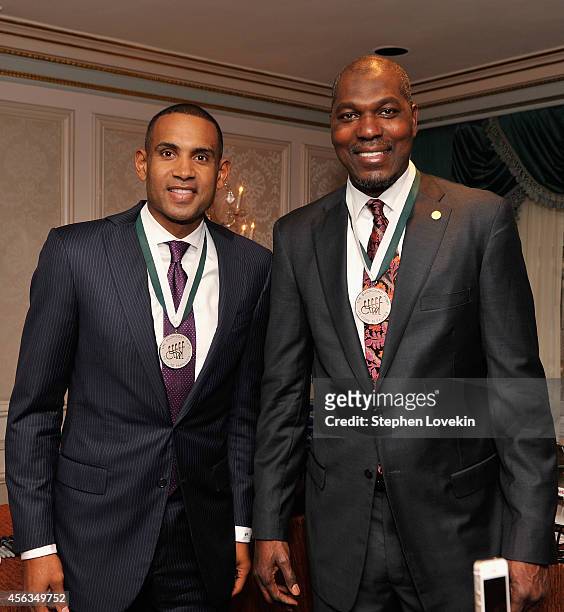 Former basketball players Grant Hill and Hakeem Olajuwon attend the 29th Annual Great Sports Legends Dinner to benefit The Buoniconti Fund to Cure...