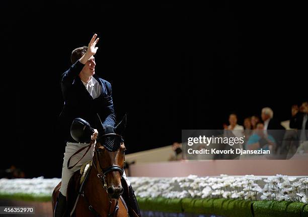 Rider Jos Verlooy of Belgium celebrates his first place finish atop Domino after the Longines Grand Prix class as part of the Longines Los Angeles...