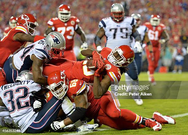 Jamaal Charles of the Kansas City Chiefs scores a touchdown against the New England Patriots during the second quarter at Arrowhead Stadium on...