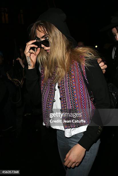 Cara Delevingne attends the Saint Laurent fashion show at the Carreau du Temple as part of the Paris Fashion Week Womenswear Spring/Summer 2015 on...