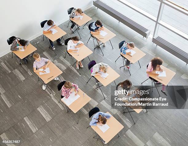 students taking a test in classroom - eye exam stockfoto's en -beelden