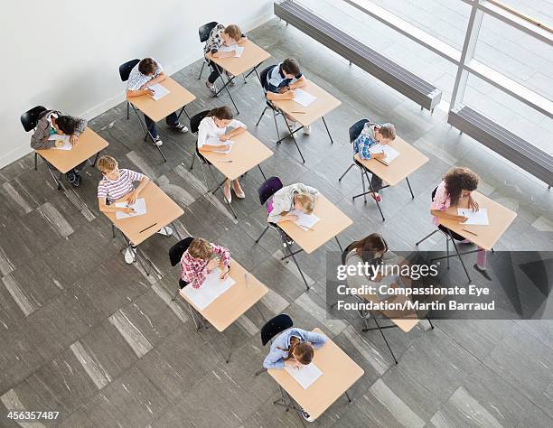 students taking a test in classroom - examinations stock pictures, royalty-free photos & images