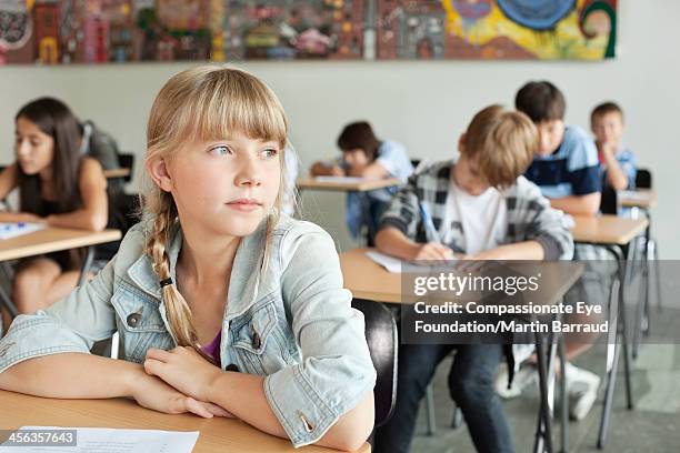 students taking test in classroom - scolara foto e immagini stock