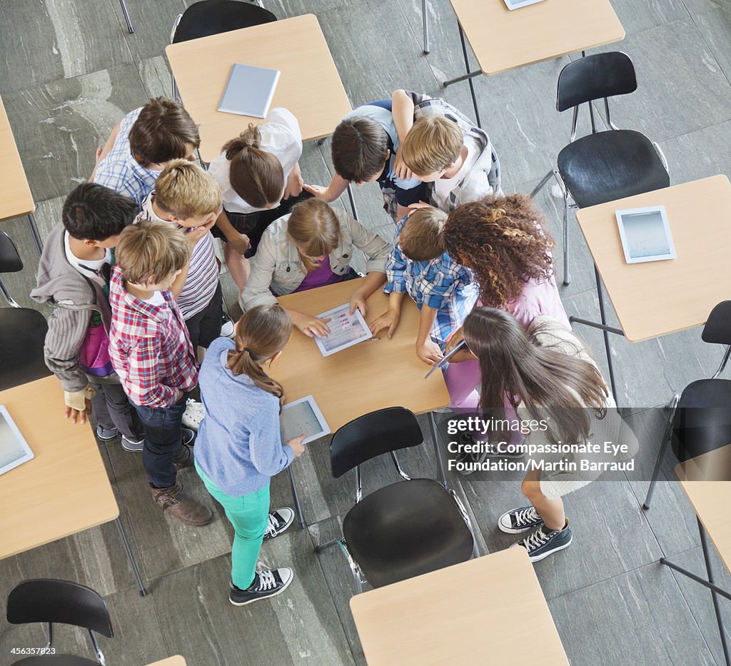 Students using digital tablets in classroom