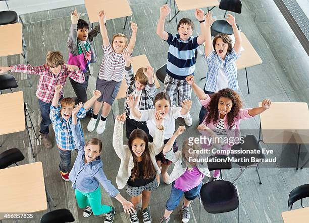 students celebrating in classroom - human age stock pictures, royalty-free photos & images