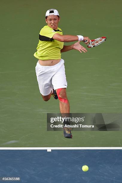 Tatsuma Ito of Japan in action during the men's singles first round match against Stan Wawrinka of Switzerland on day two of Rakuten Open 2014 at...