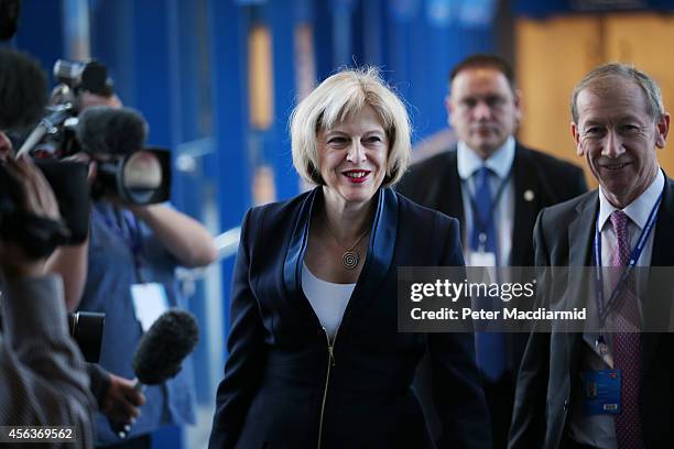 Home Secretary Theresa May walks to the Conservative party conference on September 30, 2014 in Birmingham, England. The third day of conference will...