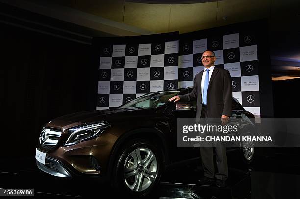 Managing Director and CEO of Mercedes-Benz India, Eberhard Kern, poses for a photograph alongside a Mercedes-Benz GLA-Class luxury SUV car during the...