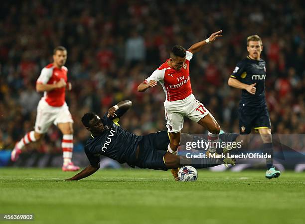 Victor Wanyama of Southampton tangles with Alexis Sanchez of Arsenal during the Capital One Cup Third Round between Arsenal and Southampton at...