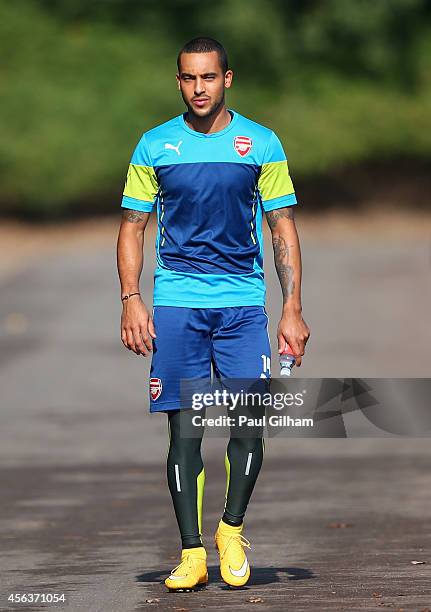 Theo Walcott of Arsenal walks out for training during an Arsenal training session ahead of their UEFA Champions League Group D match against...