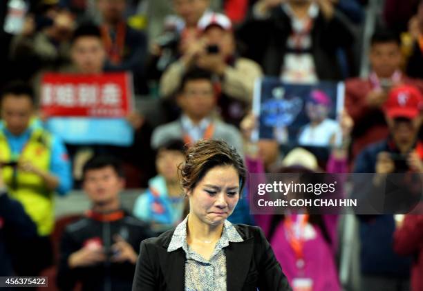 Chinese tennis star Li Na, in tears as she bids farewell to her fans during a ceremony marking her retirement, at the China Open tennis tournament in...