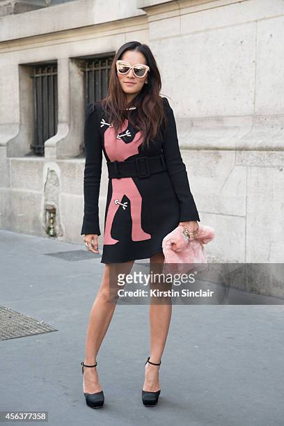Fashion Stylist Tina Leung is wearing a Carven dress, Topshop clutch, Calvin Klein shoes and Karen Walker sunglasses on day 3 of Paris Collections:...