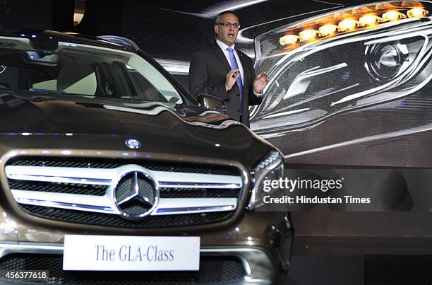 Eberhard Kern, Managing Director and CEO, Mercedes-Benz India poses for a photograph alongside a Mercedes-Benz GLA-Class luxury SUV car during its...