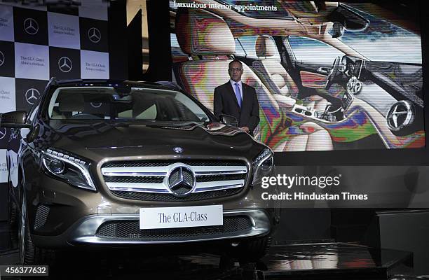 Eberhard Kern, Managing Director and CEO, Mercedes-Benz India poses for a photograph alongside a Mercedes-Benz GLA-Class luxury SUV car during its...