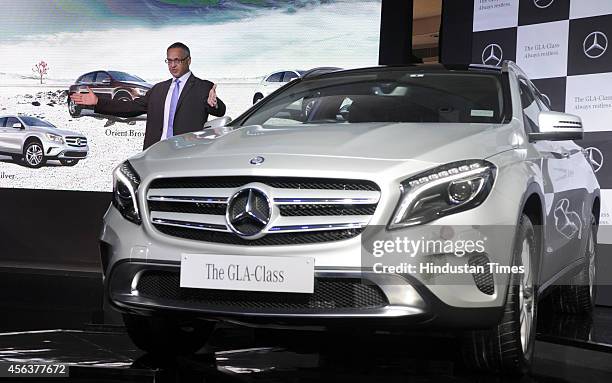 Eberhard Kern, Managing Director and CEO, Mercedes-Benz India poses for a photograph alongside a Mercedes-Benz GLA-Class luxury SUV car during its...