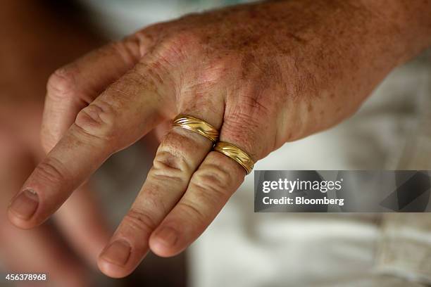 Ed Slattery displays his hand for a photograph, showing his wedding ring and the wedding ring of his deceased wife Susan that he now wears on his...