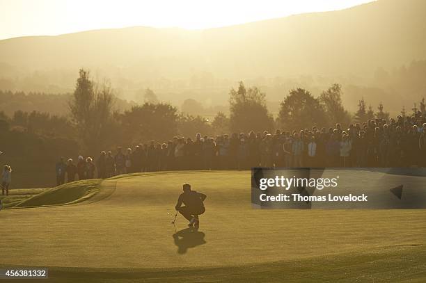 Silhouette of Team USA Bubba Watson reading putt on green during Saturday Fourball Matches on PGA Centenary Course at The Gleneagles Hotel....