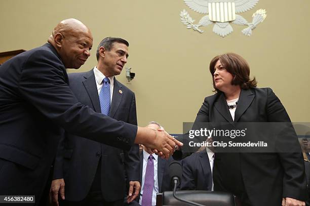 Secret Service Director Julia Pierson greets chairman of the House Oversight Committee U.S. Rep Darrel Issa and Rep. Elijah Cummings before she...