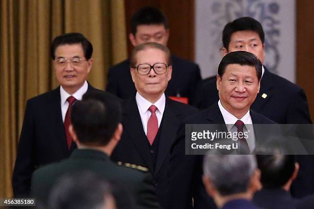 Chinese President Xi Jinping and his predecessors Hu Jintao and Jiang Zemin arrive for the National Day reception marking the 65th anniversary of the...