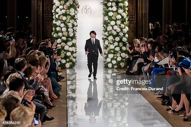 Designer Valentin Yudashkin poses on the runway after the Valentin Yudashkin show as part of the Paris Fashion Week Womenswear Spring/Summer 2015 on...