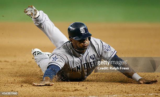 Rymer Liriano of the San Diego Padres slides head first back to first base during the seventh inning of a MLB game against the Arizona Diamondbacks...