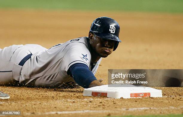 Rymer Liriano of the San Diego Padres dives back to first base during the seventh inning of a MLB game against the Arizona Diamondbacks at Chase...