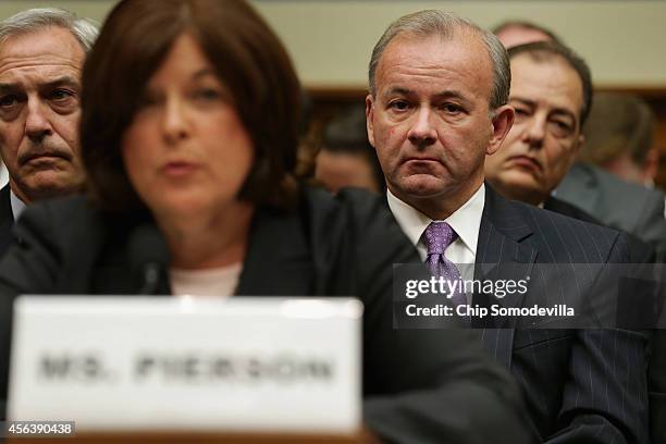 Secret Service Deputy Director A.T. Smith watchs as Director Julia Pierson testifies to the House Oversight and Government Reform Committee on the...