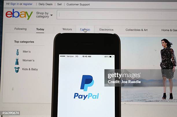 In this photo illustration, an eBay website is seen on a computer screen and the PayPal website is seen on an iphone on September 30, 2014 in Miami,...