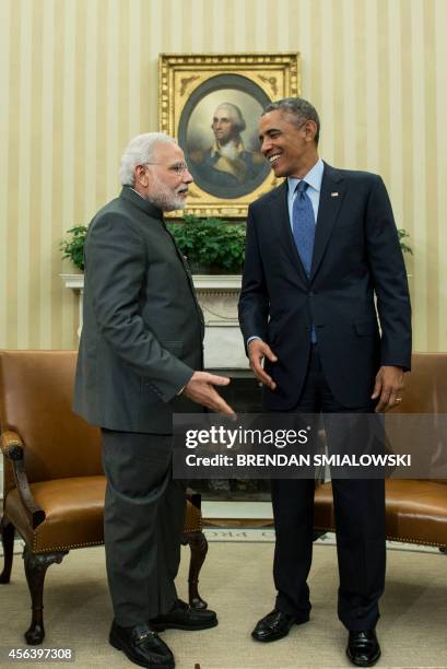 Indian Prime Minister Narendra Modi and US President Barack Obama talk after a meeting in the Oval Office of the White House September 30, 2014 in...