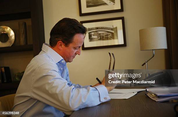 Prime Minister David Cameron prepares his keynote speech in his hotel room at the Conservative party conference on September 30, 2014 in Birmingham,...