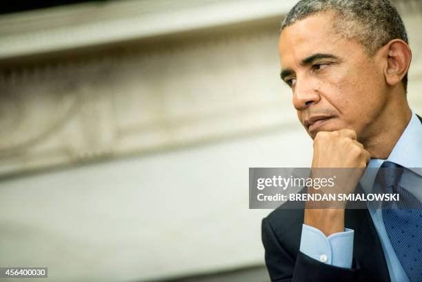 President Barack Obama listens while Indian Prime Minister Narendra Modi makes a statement to the press after a meeting in the Oval Office of the...