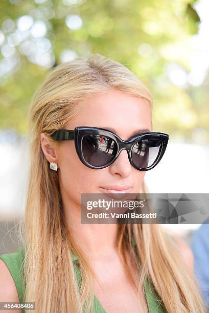 Paris Hilton poses wearing Valentino after the Valentino show on September 30, 2014 in Paris, France.