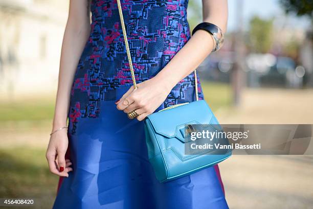 Model Liu HsinYu poses wearing Shiatzy Chen dress and bag on September 30, 2014 in Paris, France.