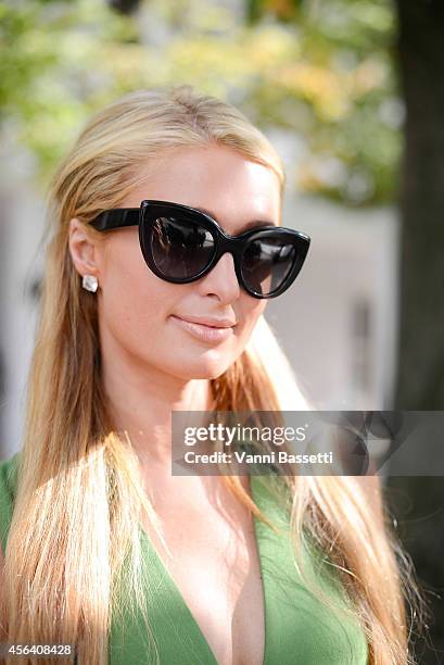 Paris Hilton poses wearing Valentino after the Valentino show on September 30, 2014 in Paris, France.