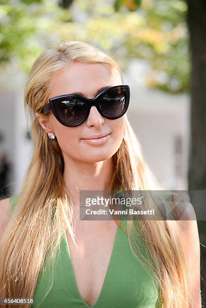 Paris Hilton poses wearing Valentino after the Valentino show on September 30, 2014 in Paris, France.