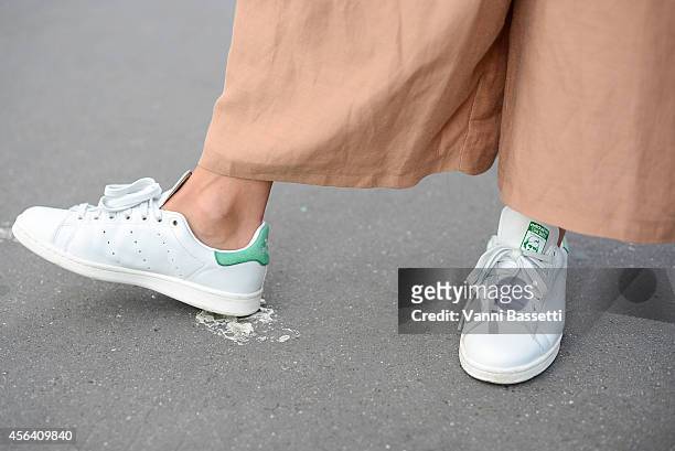 Fashion blogger Ilenia Toma poses wearing Adidas shoes and Mango pants on September 30, 2014 in Paris, France.