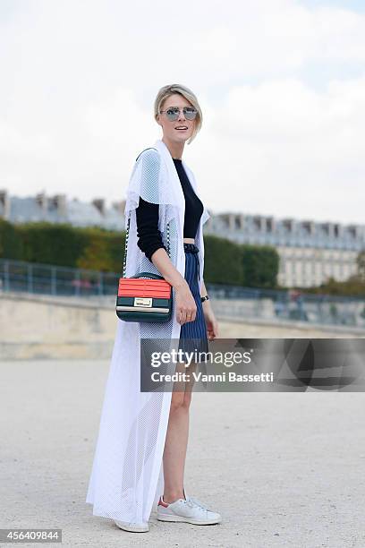 Fashion blogger Sofie Valkiers poses wearing A la Russe dress, Topshop shirt, Baum und Pferdgarten skirt, Adidas shoes, Elie Saab bag and Dior...