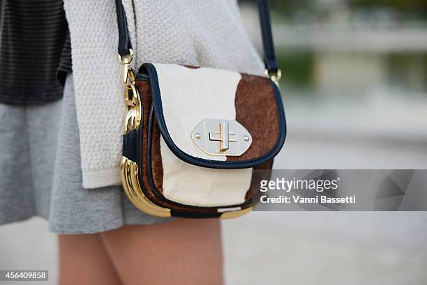 Savanna Deeioom poses wearing a Brandy cardigan and shirt and Bimba and Lola bag on September 30, 2014 in Paris, France.