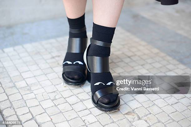 Tong Hainyin poses wearing And Other Stories shoes and Monki socks on September 30, 2014 in Paris, France.