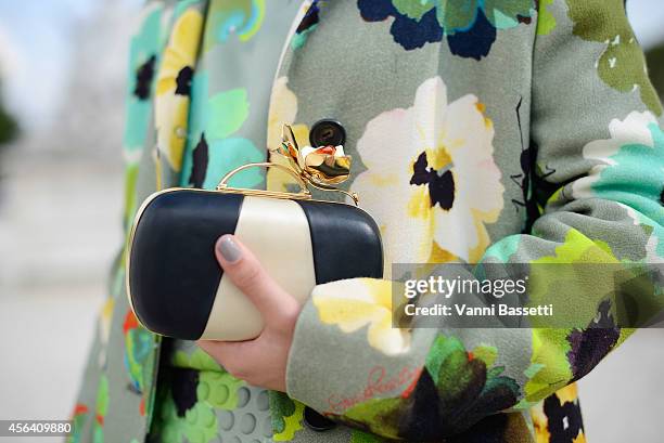 Fashion blogger Laura Comolli poses wearing a Giulia Rositani dress and Thale Blanc clutch on September 30, 2014 in Paris, France.