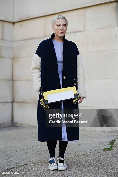 Designer Kirsty Ward poses wearing a Kirsty Ward coat and bag and Acne shoes on September 30, 2014 in Paris, France.
