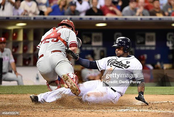 Rymer Liriano of the San Diego Padres scores ahead of the tag of Cameron Rupp of the Philadelphia Phillies during the sixth inning of a baseball game...