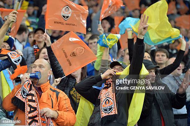 Shakhtar Donetsk supporters cheer for their team during the UEFA Champions League football match between Shakhtar Donetsk and FC Porto at the Arena...
