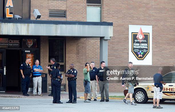 Police officers stand outside Fern Creek High School after a shooting incident September 30, 2014 in Louisville, Kentucky. Police say a male suspect...