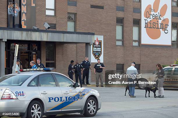 Police officers stand outside Fern Creek High School after a shooting incident September 30, 2014 in Louisville, Kentucky. Police say a male suspect...