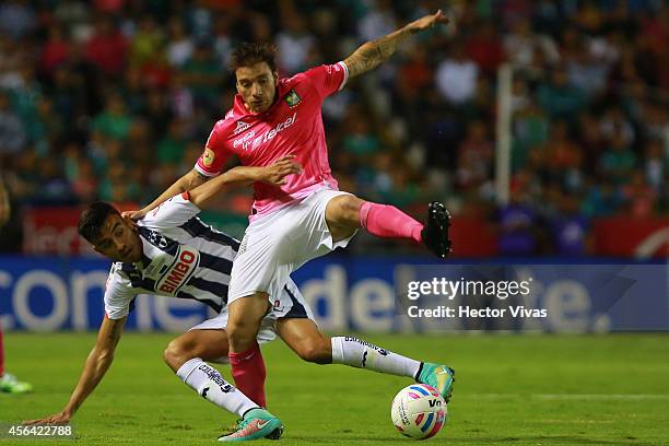 Pablo Bottinelli of Leon struggles for the ball with Jesus Zavala of Monterrey during a match between Leon and Monterrey as part of 11th round...