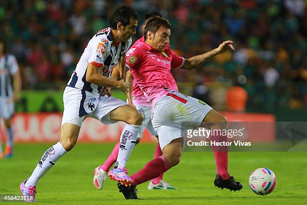 Pablo Bottinelli of Leon struggles for the ball with Cesar Delgado of Monterrey during a match between Leon and Monterrey as part of 11th round...