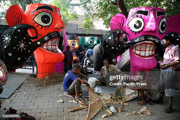 An artist prepares the effigy of Demon King Ravana for Vijaya Dashmi or Dussehara Festival in New Delhi. Hindu devotees burn effigy of Demon King...